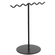 a black metal stand with two hooks on it's sides and one hook in the middle