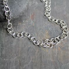 Medium Handmade Sterling Silver Round Link Gender Neutral Necklace Are you looking for a timeless statement necklace for someone special?  Do you need a classic chain for someone who is hard to buy for?  This simple yet elegant handcrafted oval & round chain will last forever and would make the perfect gift. And it costs a fraction of silver chains that come in a blue box and a bow!  Here are the details: * This beautiful necklace starts off as sterling silver 16 gauge wire and a clasp...total weight is about an ounce of sterling silver and the completed length is about 23". The links were individually cut, soldered and shaped and finished with a lobster clasp. This item was handmade by Will Macy in Corvallis, OR.  Handmade chains:  https://accentyourself.etsy.com?section_id=40383680 Our E Handmade Chains, Plain Silver Rings, Sea Glass Bracelet, Silver Chain For Men, Sea Glass Earrings, Silver Chains, Sea Glass Necklace, Glass Bracelet, Blue Box