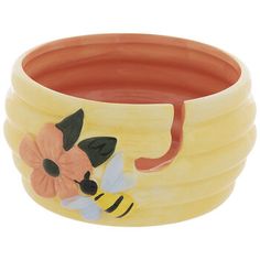 a set of four ceramic bowls with flowers and bees painted on the sides, sitting next to each other