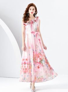 Beguiling in its ethereal beauty, this sleeveless maxi dress is a masterpiece of artful prints and soft, flowing fabric. The whimsical pattern evokes a dreamlike cityscape, enriched with vibrant splashes of color that mimic the transient beauty of a sunset skyline. The high neckline is graced with delicate ruffles, lending a romantic air to the overall design. A sash cinches the waist, offering a flattering silhouette, while the lightweight material dances around the ankles, perfect for an eveni Garden Soiree, Flowing Fabric, Flounce Skirt, Dress Sleeve Length, Floral Patchwork, Full Length Skirts, Ethereal Beauty, Printed Dress, Bohemian Dress