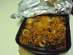 a pan filled with food sitting on top of a table next to a piece of tin foil