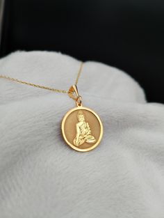 Elevate your style with our exquisite 14K Gold Buddha Necklace, a meticulously handmade masterpiece that seamlessly blends spirituality and elegance. This dainty and intricate religious charm necklace serves as a timeless symbol of peace and tranquility, making it the perfect accessory for those seeking a touch of Zen in their everyday lives. Embrace the serenity of our Yoga Necklace, thoughtfully designed to bring a sense of balance and mindfulness to your wardrobe. ⭐ Package included: One Handmade Necklace ⭐ Pendant Sizes: 14 / 16 / 18 / 20 / 22 / 24 / 26 / 28 / 30 mm ⭐ Necklace Length: 14 / 16 / 18 / 20 / 22 inches ⭐ Materials: 925 Sterling Silver / Gold Plated / 14K Solid Gold Frequently asked questions: ✈️ Express and Free Shipping with UPS. 📦 Items will be shipped within 1-2 busines Handmade 14k Gold Spiritual Necklace, Spiritual Round Gold-plated Necklaces, 14k Gold Spiritual Necklaces For Meditation, Spiritual Round Necklaces For Meditation, Handmade Spiritual Yellow Gold Necklaces, Spiritual Round Pendant Necklaces For Wedding, Spiritual Medallion Necklace For Wedding, Handmade Gold Necklaces For Meditation, Spiritual Wedding Necklace With Coin Pendant