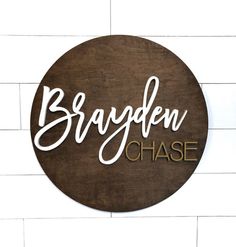 wooden sign with the words braaden chase written in cursive writing on it