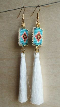 earrings with tassels and beads hanging from hooks