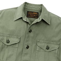 This versatile overshirt provides an added layer of protection on cool days in the field. Patterned after our original iconic Jac-Shirt that’s been a favorite since the 1970s, its versatility makes a sure go-to favorite. The strong midweight fabric is a reverse-sateen weave, smooth on the inside for easy layering. Sturdy buttons secure the front, chest-pocket flaps, and adjustable cuffs. Straight hem for untucked wear. Spread collar. | Filson Field Jac-shirt - WshdFtgGrn Size Large Outdoor Cotton Tops With Flap Pockets, Cotton Tops With Flap Pockets For Outdoor, Outdoor Button-up Tops With Patch Pockets, Button-up Tops With Patch Pockets For Outdoor, Collared Tops With Patch Pockets For Outdoor, Cotton Military Tops For Outdoor Activities, Outdoor Cotton Shirt With Patch Pockets, Collared Utility Shirt For Outdoor, Military Tops With Pockets For Outdoor Activities