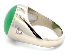 Item Specifications:Metal: 14k White Gold Style: Statement RingRing Size: 10.25 (resizing available for a fee)Total Weight: 15.5 GramsGemstone Specifications:Center Gemstone: Jadeite JadeShape: OvalColor: GreenCut: Cabochon Jade Carat Weight: ~18 CaratsJade Measurements: 17.2 mm x 13.5 mm x 8.5 mmDiamond Carat Weight: 0.10Diamond Clarity: VSDiamond Color: GCondition: Vintage, Excellent Jade Diamond Ring, Vs Diamond, Style Statement, Diamond Clarity, Gold Style, Timeless Beauty, Colored Diamonds, Statement Rings, Diamond Ring