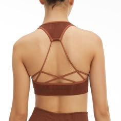 New Year, New You. Meet The Seamless Strappy Back Rib Bra. Innovative Workout Fabrication For The Smoothest Shape And Fit Yet. Pair It With The Seamless Ribbed Legging For The Full Look. Square Neckline Strap Back Ribbed Textured Seamless Construction Medium Support Padded Brown Color 93% Nylon 7% Elastane Care: Machine Wash Cold Gentle Cycle. Tumble Dry Low S/M Order Size 1/2 Strappy Stretch Crop Top For Yoga, Brown Stretch Crop Top With Built-in Bra, Strappy Seamless Stretch Bra, Seamless Strappy Stretch Bra, Seamless Stretch Strappy Bra, Seamless Sleeveless Yoga Bra, Strappy Stretch Seamless Crop Top, Stretch Strappy Seamless Crop Top, Stretch Seamless Strappy Crop Top