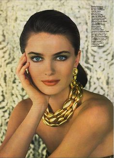 a woman with blue eyes is posing for a magazine advertiser's photo