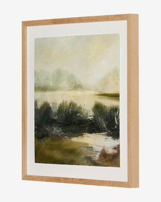 a painting hanging on a wall next to a wooden framed artwork piece with water and trees in the background