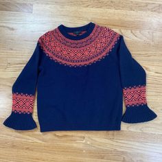 Beautiful navy blue sweater with geometric neon orange pattern along the top and sleeves.  Fun bell sleeves that flare out and add so much to the outfit.  This item is size Small and is still new with tags.  60% Merino Wool and 40% Nylon. Measurements laying flat: 20" Chest 23.5 Length 27" Arm Length 18.5" Waist Item is in excellent condition, new with tags.  Please review all photos and the listing video provided for full details and description of item condition.  Thank you for visiting our sh Navy Fitted Sweater For Fall, Navy Fitted Long Sleeve Sweater, Fun Sweaters, Pull Bleu Marine, Navy Blue Sweater, Orange Pattern, Blue Sweater, Cool Sweaters, Vintage Wear