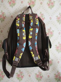 "Vintage backpack, brown with a blue and yellow flower pattern on the front, sides and straps.There are two side pockets and a front zip pocket. There are two zips on the top and a flap pocket inside, the shoulder straps are padded and adjustable. Reasonable condition Dimensions  Width;  13\"                         Height;  18\"                          Depth;  6\"        Made in France" Retro Brown Backpack For School, Retro Brown School Backpack, Vintage Brown Backpack For Trip, Brown Vintage Backpack For Trips, Brown Floral Print Shoulder Bag For Travel, Angelic Accessories, Vintage Backpacks, Rucksack Backpack, Floral Bags