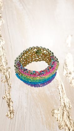 "Add some sparkle to your wrist with these gorgeous glittery bracelets. Glitter stays on and won't mess up!  Choose your favorite from the drop down menu.  **Please note the shipping time. This specific bracelet is a pre order, which means it will take anywhere between 1 to 2 weeks to arrive. To ensure a proper size, use a tape measure around your wrist. Place a dot where the tape measure meets. That is your wrist size! In our drop down menu, we have also included the average sizes for you. Plea Trendy Adjustable Bling Bracelet, Trendy Beaded Crystal Bracelet For Party, Rainbow Bangle Bracelets For Party, Rainbow Bangle Bracelet For Parties, Rainbow Bangle Bracelet For Party, Adjustable Iridescent Bracelet For Parties, Adjustable Multicolor Sparkling Jewelry, Adjustable Sparkling Multicolor Jewelry, Adjustable Sparkling Beaded Bracelets For Parties