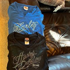 Two Great Hd Tee Shirts. Women’s Medium. Blue Shirt Almost Never Worn. Black Shirt Very Lightly Used. Smoke Free Home. No Stains Or Tears. Get Yourself A Deal! Harley Davidson Tee, Shirts Women, Stain Colors, Blue Shirt, Fancy Dresses, Medium Blue, Black Blue, Black Shirt, Harley Davidson