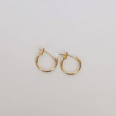 Add a touch of elegance to your everyday look with our 10k yellow solid gold huggie earrings. These timeless earrings are crafted to hug your earlobe comfortably and securely, making them perfect for everyday wear. And, with their simple yet stylish design, they're the ideal foundation for adding your favorite charms to create a personalized look that's uniquely yours. Try adding our Medusa Pendant for an edgy drop earring style. Details Crafted in solid 10k yellow gold for strength, comfort, an Classic Everyday Hypoallergenic Huggie Earrings, Classic Small Hoop Yellow Gold Cartilage Earrings, Classic Tarnish-resistant Huggie Cartilage Earrings, Classic Yellow Gold Small Hoop Cartilage Earrings, Everyday Yellow Gold Huggie Earrings In Sterling Silver, Everyday Yellow Gold Sterling Silver Huggie Earrings, Simple Yellow Gold Tarnish Resistant Huggie Earrings, Simple Yellow Gold Tarnish-resistant Huggie Earrings, Classic Everyday Hypoallergenic Cartilage Earrings