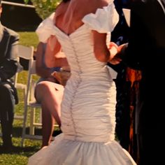 a woman in a wedding dress walking down the aisle