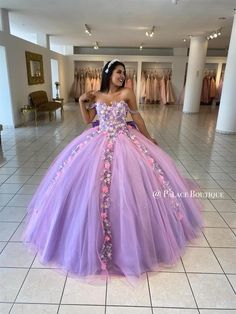 a woman wearing a purple and pink dress in a room with white tile flooring