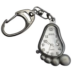 a metal keychain with a silver pocket watch on it's face and hands