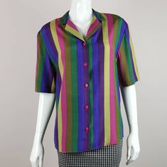 80s vintage vibrant bold striped shirt. Details: *Relaxed fit with notched collar and short sleeves. *Button down front. *Mixed colour wide stripe print. *Viscose material. *Excellent condition. Size estimate: m UK: 12 US: 10 EU: 40 Measurements: bust: 40in length: 27in Thank you for looking and please let me know if you have any questions - I am always happy and quick to help ⭐ ❤️ Click the heart button and add our shop to your favourites, so you can be alerted to new listings, sales and coupons! ❤️ Remember your special code (5OFFMYFAVE) for £5 discount at checkout ^-^ *browse Etsy shop here* www.etsy.com/uk/shop/AgeOfVintageUK p.s discover what our customers are saying by checking out our reviews :)  S/M Retro Multicolor Short Sleeve Shirt For Spring, Retro Multicolor Short Sleeve Shirt, Multicolor Retro Short Sleeve Shirt, Rainbow Print Short Sleeve Shirt, Summer Short Sleeve Blouse With Striped Collar, Multicolor Short Sleeve Tops With Striped Collar, Multicolor Short Sleeve Top With Striped Collar, Retro Short Sleeve Purple Shirt, Retro Multicolor Short Sleeve Blouse