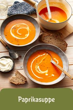 two bowls of soup on a wooden table