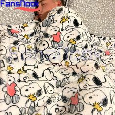 a baby wrapped up in a blanket with cartoon animals on it's back and head