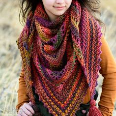 a woman wearing a multicolored knitted scarf