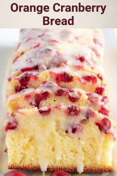 a close up of a cake on a plate with cherries around it and drizzled with icing