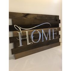 a wooden sign that says home on it