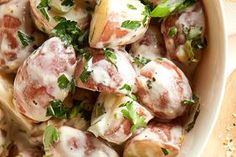 a white bowl filled with meat and vegetables