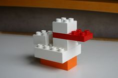 an orange and white lego boat on a table