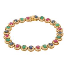 Emerald, Ruby, Blue Sapphire and Diamond bracelet in 18K Gold. It has a perfect oval cut gemstone to make you stand out on any occasion or an event. A tennis bracelet is an essential piece of jewelry when it comes to your wedding day. The sleek and elegant style complements the attire beautifully, whether it's the bride wearing it herself, or as a gift to her bridesmaids to wear on the D’day.  Bracelets are worn to enhance the look. Women love to look good. It is common to see a woman rocking a Luxury Oval Multi-stone Tennis Bracelet, Elegant Multi-stone Oval Tennis Bracelet, Formal Multi-stone Cubic Zirconia Tennis Bracelet, Elegant Oval Multi-stone Tennis Bracelet, Oval Multi-stone Tennis Bracelet In Fine Jewelry Style, Classic Oval Multi-stone Bracelet, Luxury Multi-stone Round Tennis Bracelet, Wedding Bracelets With Gemstone Accents, Elegant Multi-stone Round Tennis Bracelet