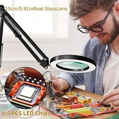 a man is working on an electronic circuit board with magnifying glass and light