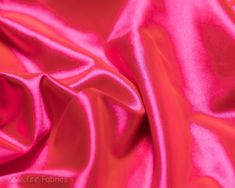 a close up view of a pink satin fabric