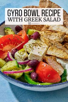 a bowl filled with greek salad and pita bread