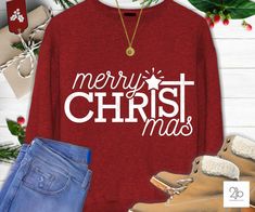 a red shirt that says merry christmas next to jeans and boots