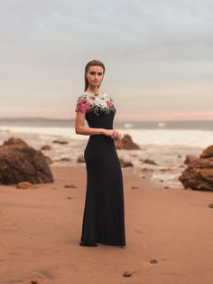 This gown features delicate floral embellishments on a figure-flattering jersey fabric. With its fitted silhouette, it exudes elegance and sophistication. Perfect for formal events or evening affairs. Mac Duggal Hand-embellished mesh bodice; jersey skirt (100% polyester) Partially lined bodice; fully lined skirt; semi-sheer unlined sleeves Round illusion high neckline Short sleeve Intricate floral detailing Concealed back zipper Approx. 60" from top of shoulder to bottom hem Available in Black M Designer Prom Dress, Vestidos Color Coral, Mac Duggal Dress, Fitted Gown, Summer Bridesmaid Dresses, Fitted Gowns, Long Formal Dress, Jersey Skirt, Bride Groom Dress