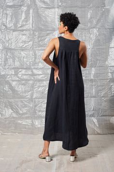 The Pleated Shift Dress features foldover detailing at the neck as well as a relaxed, streamlined silhouette and midi length. Added in-seam pockets and side-seam hem slits allow for added utility and ease of movement. Chic Black Dresses With Slip Pockets, Chic Black Dress With Slip Pockets, Chic Midi Maxi Dress With Pockets, Chic Daywear Maxi Dress With Pockets, Chic Midi Dress With Slip Pockets For Work, Linen Maxi Dresses For Loungewear, Relaxed Fit Midi Dress With Side Slits, Sleeveless Relaxed Fit Midi Dress For Loungewear, Daywear Longline Maxi Dress