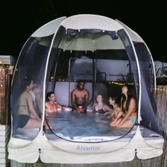 an inflatable hot tub with people sitting around it