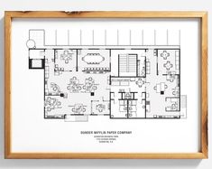 a drawing of a restaurant floor plan in a wooden frame on the wall above it