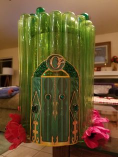 a green glass vase sitting on top of a table