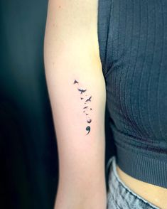 a woman's arm with three birds flying in the sky and two moon on it