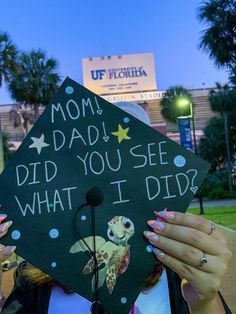 a woman wearing a graduation cap that says mom, dad, did you see what i did?