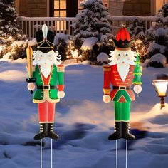 two christmas nutcrackers standing in the snow