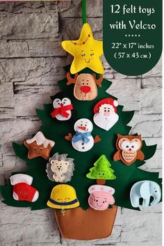 felt toys with velcco are hanging on the wall next to a christmas tree