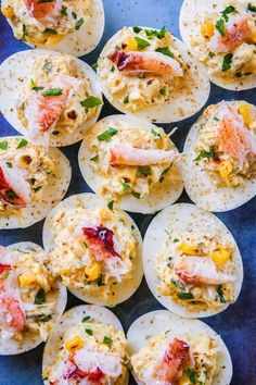 deviled eggs filled with crab and cheese on a blue plate