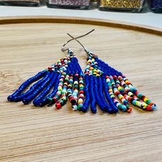 These African Maasai Zulu Style inspired Tribal earrings are definitely a standout. If you love African jewelry styles and these statement earrings, these are your earrings. Vibrant Dangle Earrings With Ear Wire, Adjustable Blue Tassel Earrings With Colorful Beads, Blue Tassel Drop Earrings, Vibrant Blue Drop Earrings, Blue Tassel Drop Earrings With Dangling Beads, Vibrant Colorful Bead Drop Earrings, Handmade Blue Chandelier Earrings, Vibrant Drop Earrings With Colorful Beads, Vibrant Blue Dangle Earrings