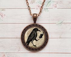 Meet the Raven Necklace, an eye-catching jewel that will add mystery and elegance to your collection. Hanging from a delicate brass chain, the pendant adds a sophisticated touch to any outfit. The vintage brass plating gives the necklace a rustic look, making it the perfect accessory for a bohemian or gothic style. *Necklace is made of a high quality metal base, solid chain, crystal resin and a high quality printed image underneath. *Chain length: 23 inch (58 cm) *Pendant size: 1,37 inch (3,5 cm Victorian Style Copper Necklace As Gift, Victorian Copper Necklace As Gift, Victorian Copper Necklace For Gift, Vintage Antique Finish Necklace As Gift, Vintage Necklace With Antique Finish As Gift, Antique Gold Copper Necklace For Gift, Vintage Antique Finish Necklace For Gift, Antique Copper Necklace For Gift, Copper Necklace With Antique Finish And Round Pendant