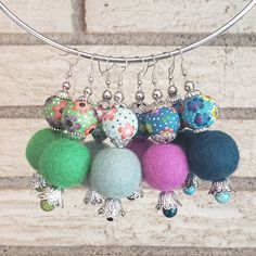 a bunch of different colored balls hanging from a wire