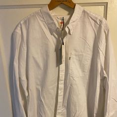 Never Worn, Still Has Tags, Xxl, Perfect Condition Casual Levi's Shirt With Buttons, Levi's Long Sleeve Shirt For Spring, Classic Long Sleeve Levi's Tops, Levi's Long Sleeve Cotton Tops, Levi's White Relaxed Fit Shirt, Levi's White Cotton Shirt, Classic Levi's Button-up Top, Levi's Button-up Summer Tops, Levi's Long Sleeve Shirt With Pockets