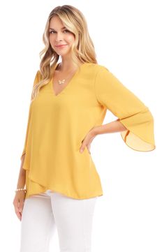 An elegant top of silky, lightweight crepe delivers elegant movement with its angled flare sleeves and fluttery asymmetrical hemline that dips low in back. 25 1/2" length (size Medium) V-neck Three-quarter sleeves Back yoke with gathering Crossover high/low hem 100% polyester Dry clean or hand wash, line dry Made in the USA of imported fabric Women's Clothing Flowy Asymmetrical Hem Blouse For Spring, Flowy Spring Blouse With Asymmetrical Hem, Flowy Blouse With Asymmetrical Hem For Spring, Chic Viscose Top With Asymmetrical Hem, Chic Viscose Tops With Asymmetrical Hem, Chic Flowy Blouse With Asymmetrical Hem, Elegant Stretch Top With Asymmetrical Hem, Elegant Stretch Tops With Asymmetrical Hem, Asymmetrical Viscose Top For Spring