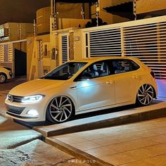 a white car parked in front of a building